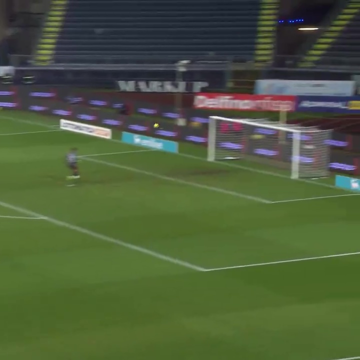 Soccer player scoring a goal.