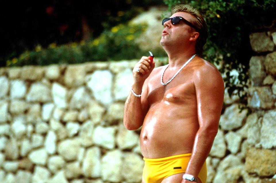 Ray Winstone in yellow swim trunks.