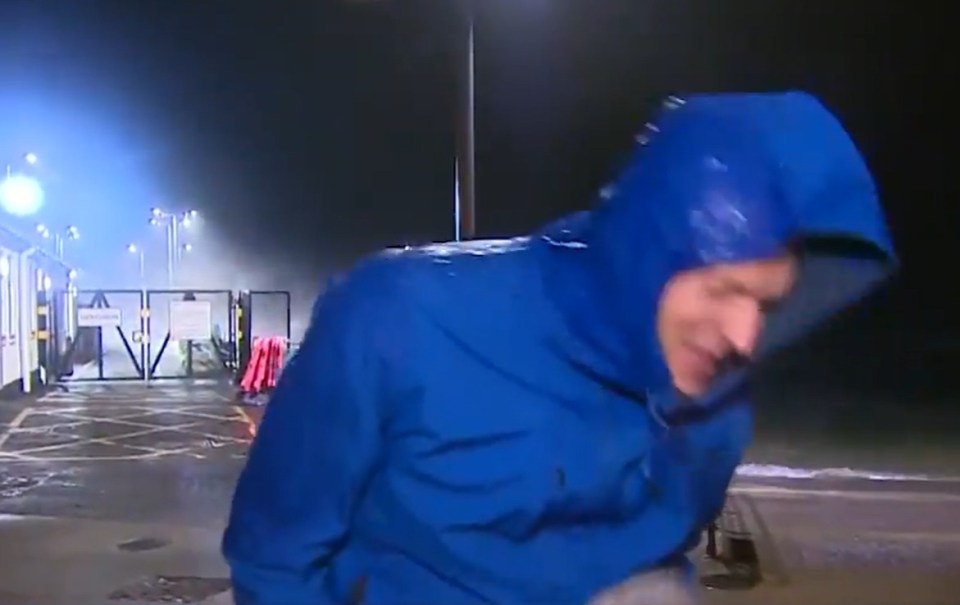 Person in blue raincoat in stormy weather.