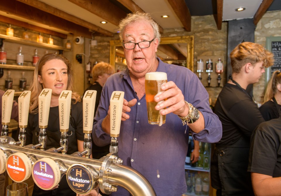 Jeremy Clarkson holding a pint of beer at the opening of his pub, The Farmer's Dog.