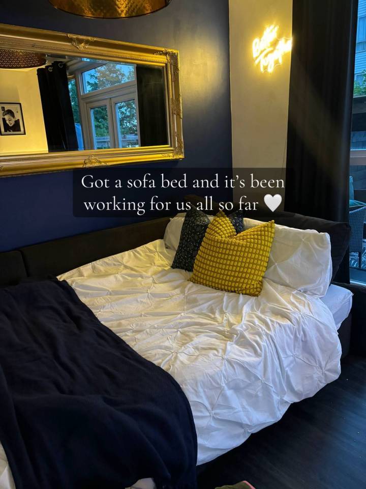 Sofa bed with white bedding and yellow pillows.
