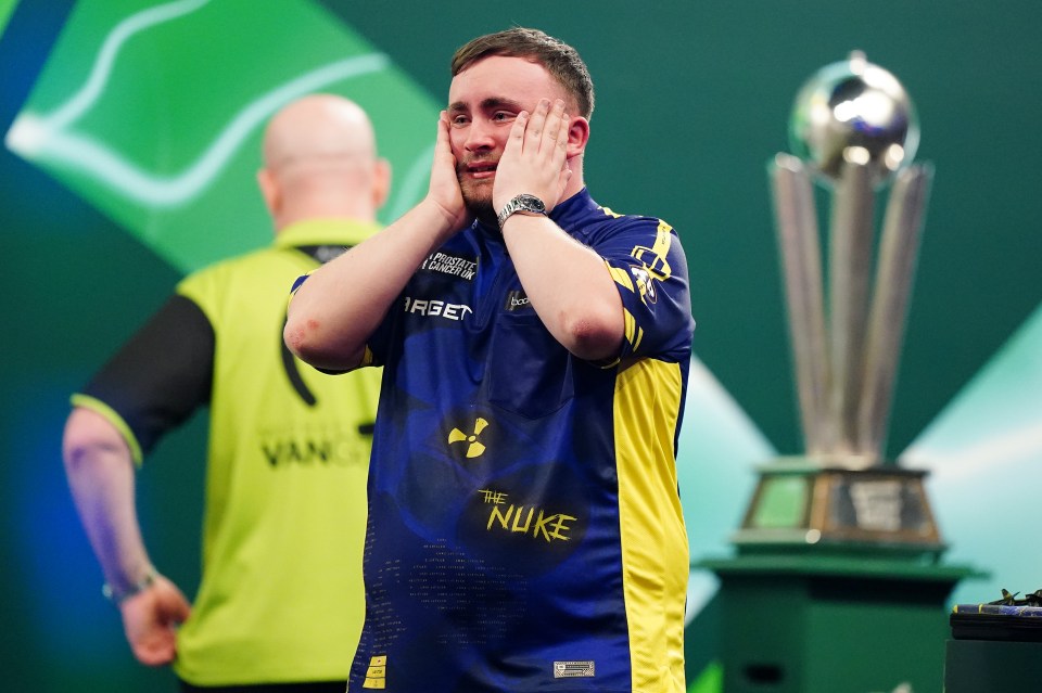 Luke Littler reacts after winning a darts championship.