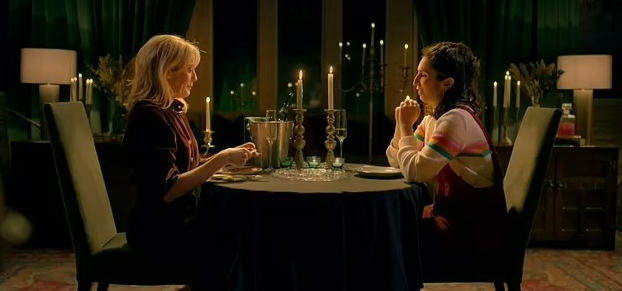 Charlotte and Frankie at a candlelit table during the Traitors finale.