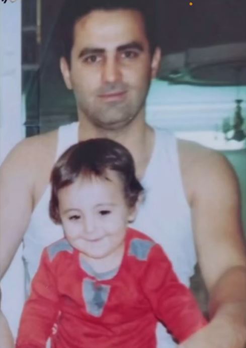 Photo of a man holding a toddler.