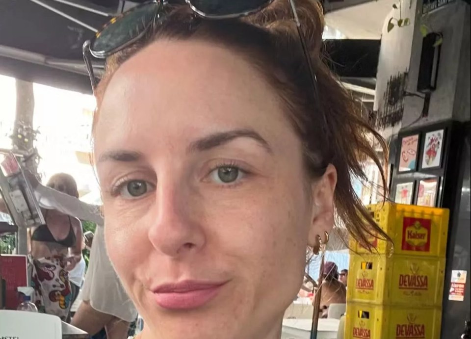 Close-up selfie of a woman outdoors.