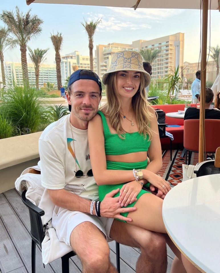 Couple sitting together at an outdoor cafe.