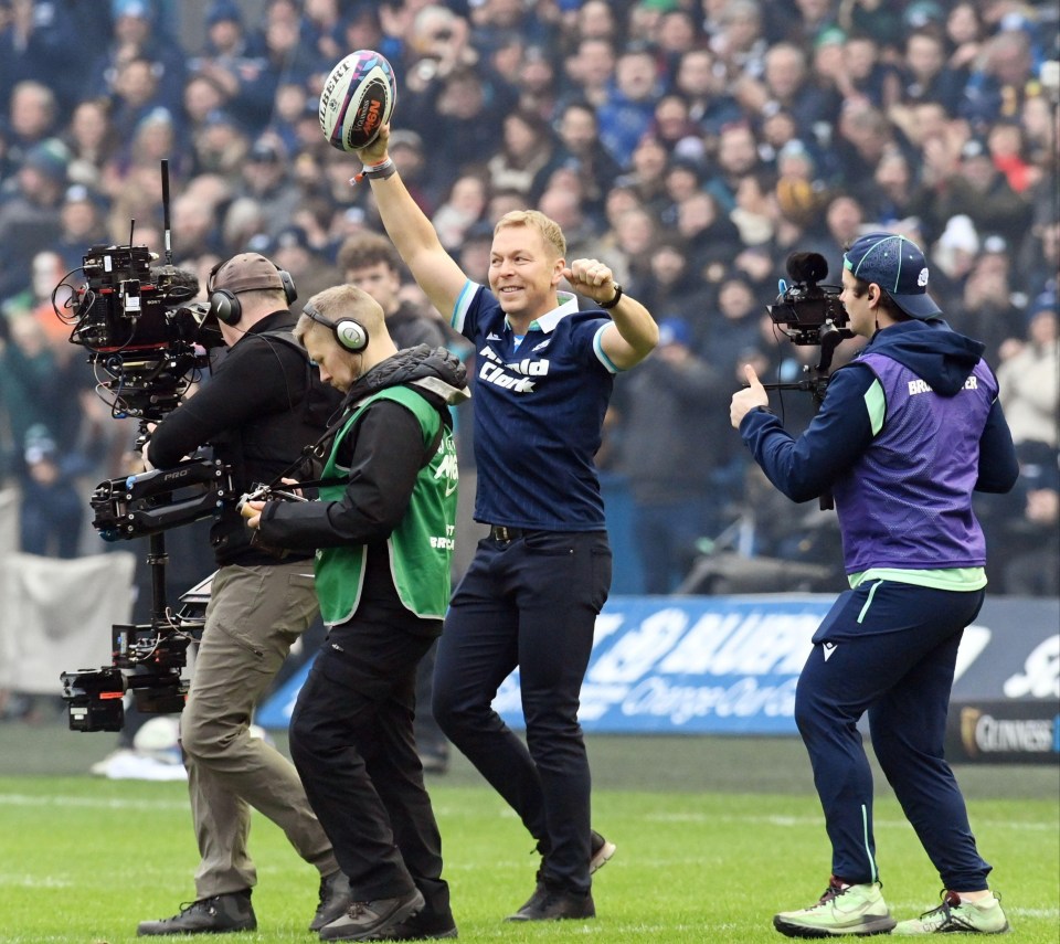Sir Chris Hoy carrying the match ball at a Scotland vs Ireland rugby match.