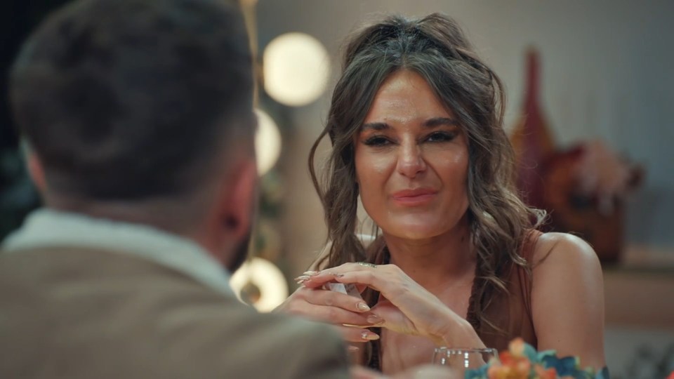 Woman smiling at man during a date.