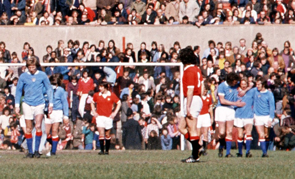 Denis Law congratulated after scoring a goal.