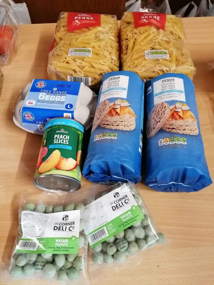 Grocery shopping haul: pasta, eggs, rice cakes, peach slices, and wasabi peanuts.