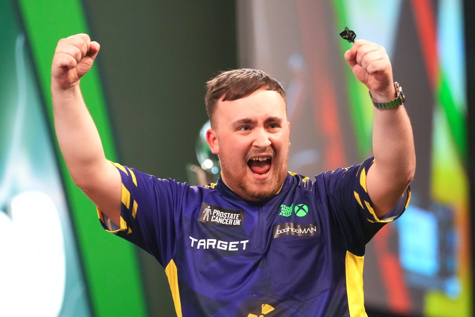 Luke Littler of England celebrates a darts victory.
