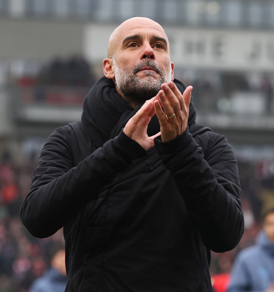 Pep Guardiola clapping at a soccer match.
