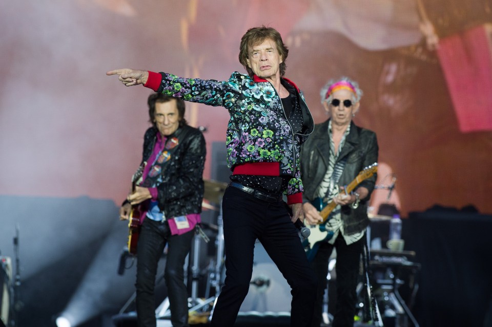 Mick Jagger, Keith Richards, and Ronnie Wood of The Rolling Stones performing on stage.