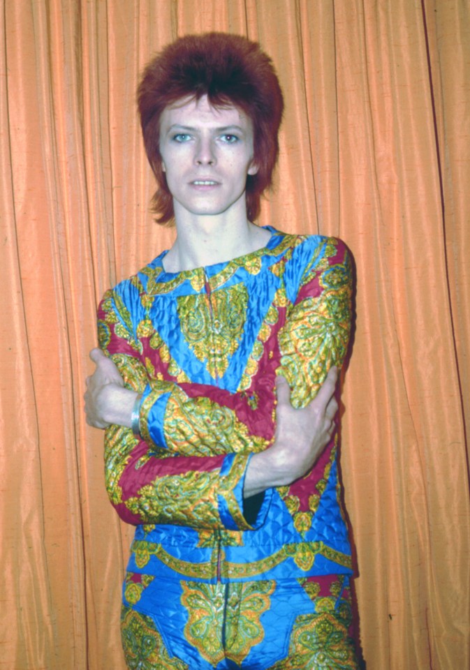 David Bowie as Ziggy Stardust in a patterned jumpsuit.