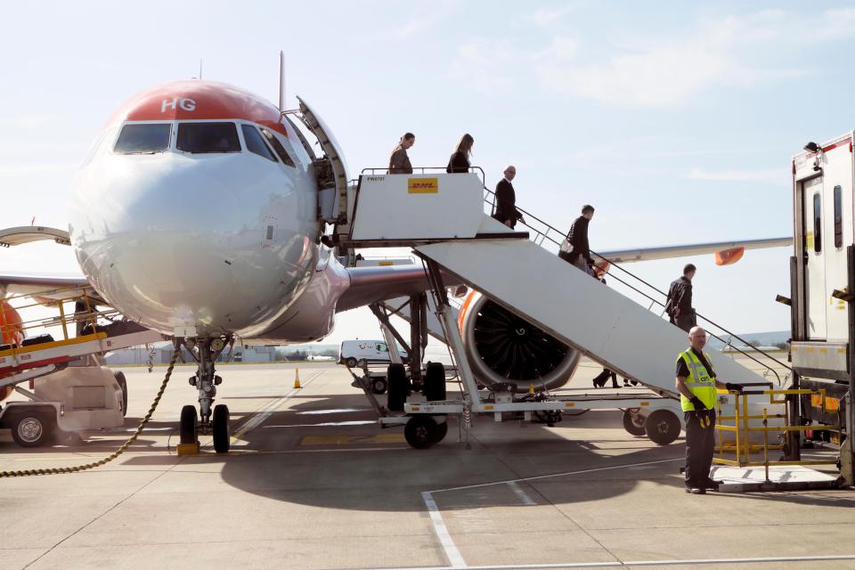 Passengers disembarking an EasyJet plane.