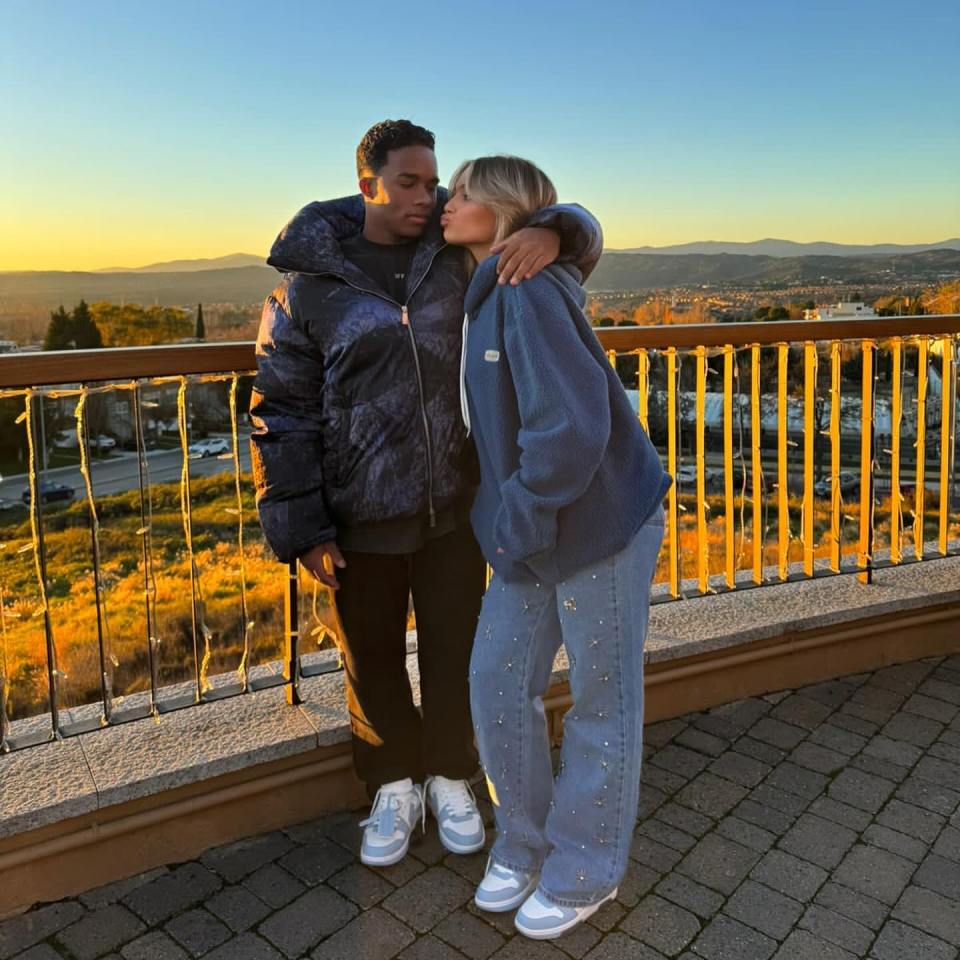 Couple embracing at sunset.
