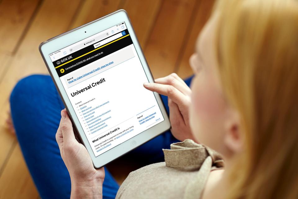 Woman using tablet to apply for Universal Credit.