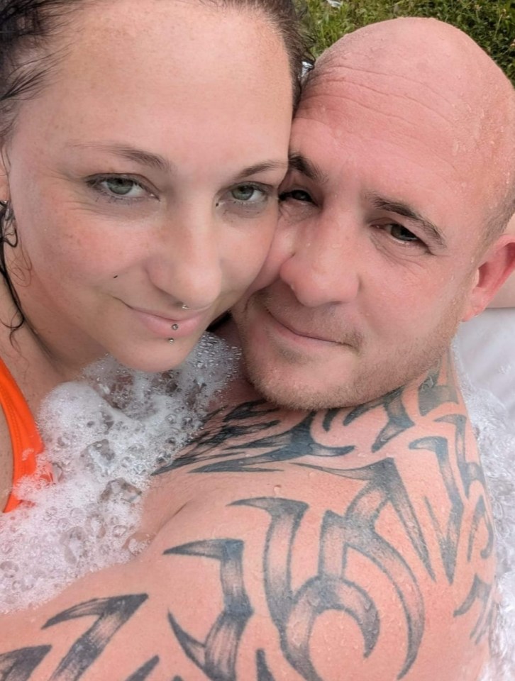 Close-up of a couple embracing in a hot tub.