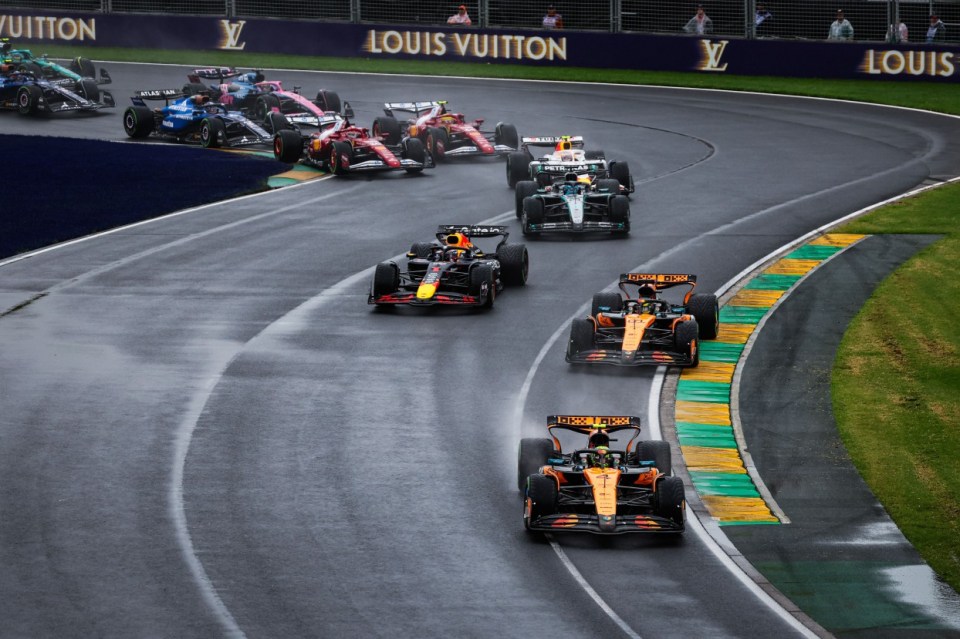 Formula 1 cars racing in the rain.