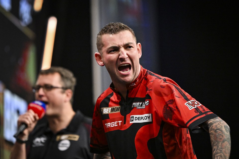 Nathan Aspinall celebrating a darts win.