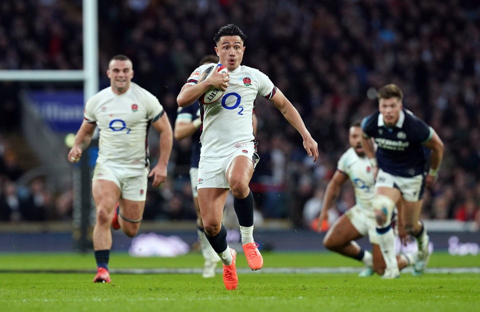 Marcus Smith of England running with the rugby ball during a match.