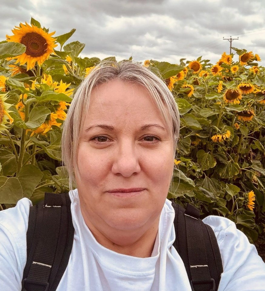 Angela Glover in a sunflower field.