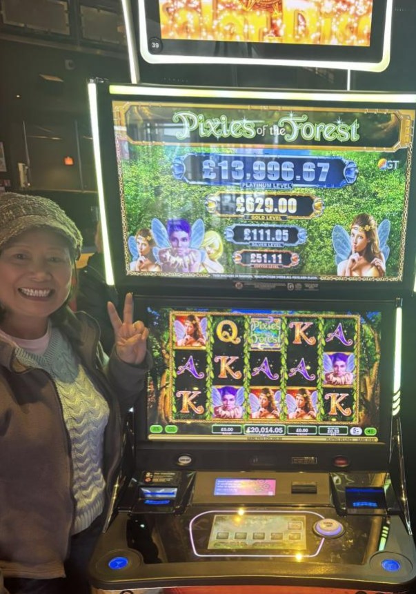 Woman winning at Pixies of the Forest slot machine.