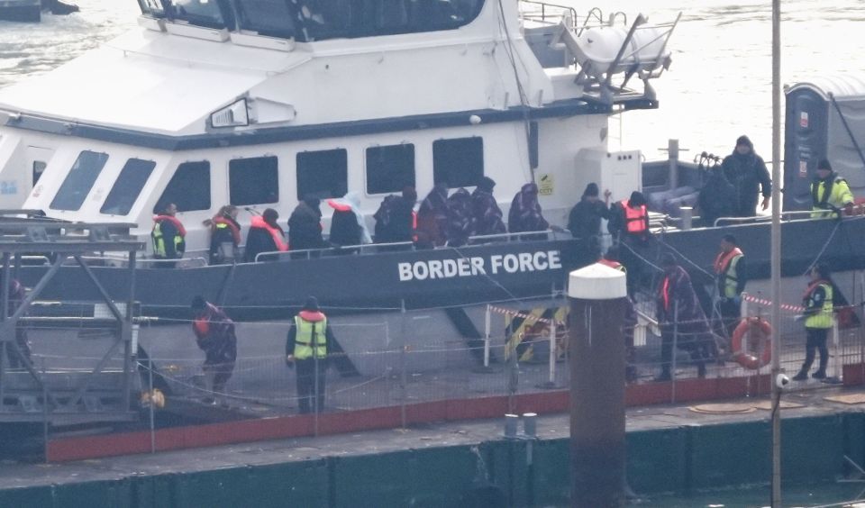 Migrants arriving in Dover on a Border Force vessel.