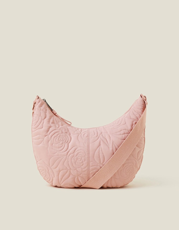 Pink quilted sling bag with rose pattern.