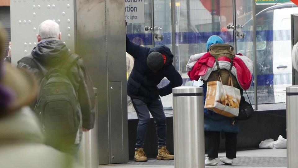 Two people appearing to be distressed near a station entrance.