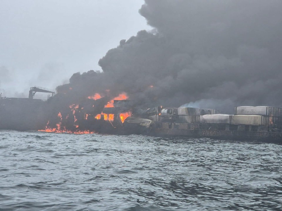 Burning oil tanker at sea.