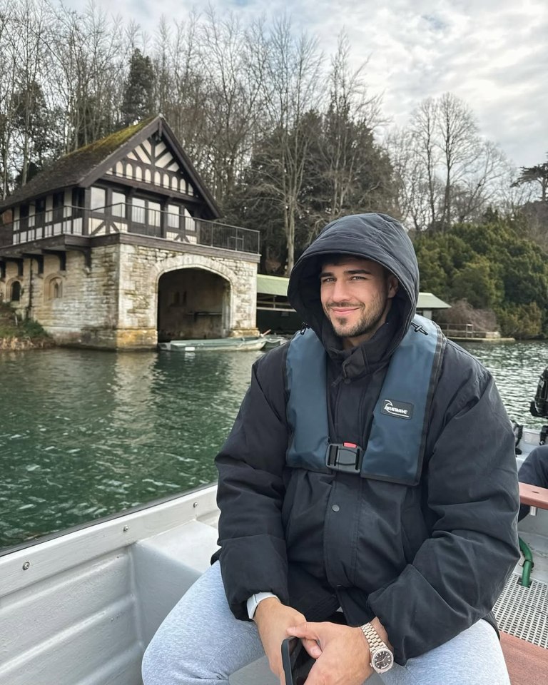 Tommy Fury on a boat, wearing a life vest.