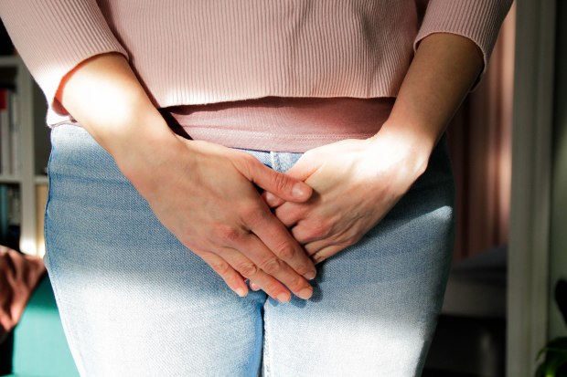 Woman holding her crotch.