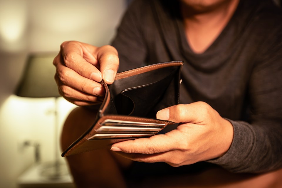 Concept of Bankruptcy,Unemployment,financial liquidity problems, finance trouble,Unemployed asian man opening empty wallet,no cash,money problem,deflation,inflation crisis,Global economic depression