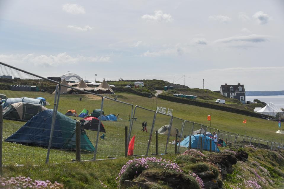 Campsite at the Masked Ball music festival near a cliff.