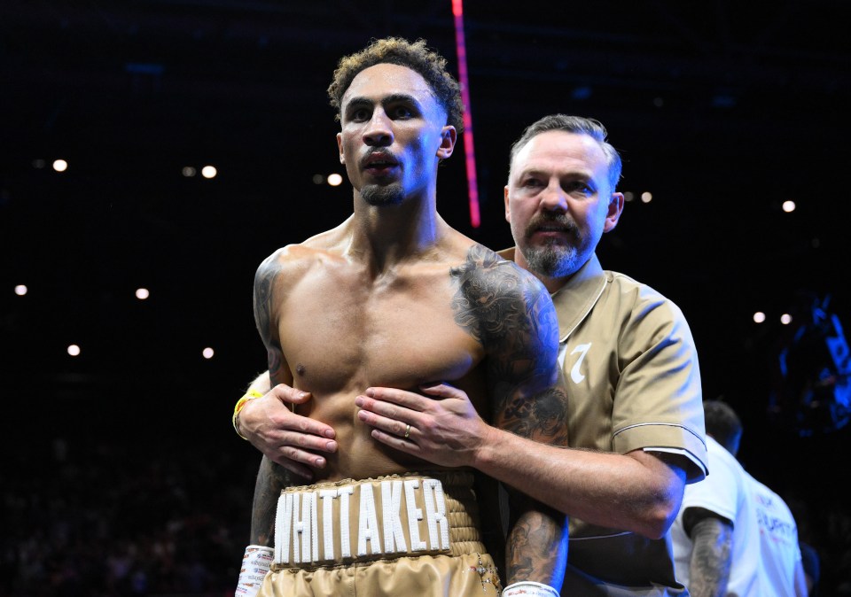 Boxer Ben Whittaker is embraced by his coach after a fight.
