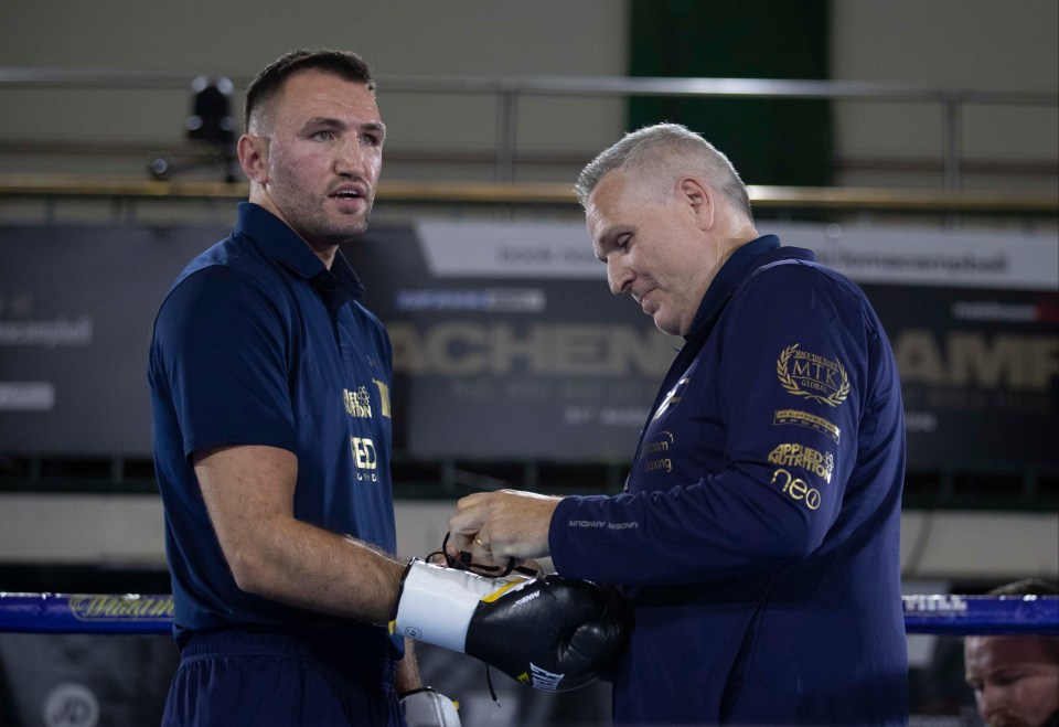Hughie Fury having his boxing gloves tied by Peter Fury.