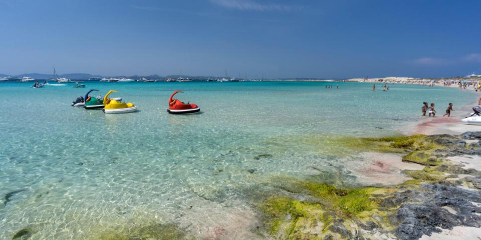 Ses Illetes beach in Formentera with paddle boats and clear water.