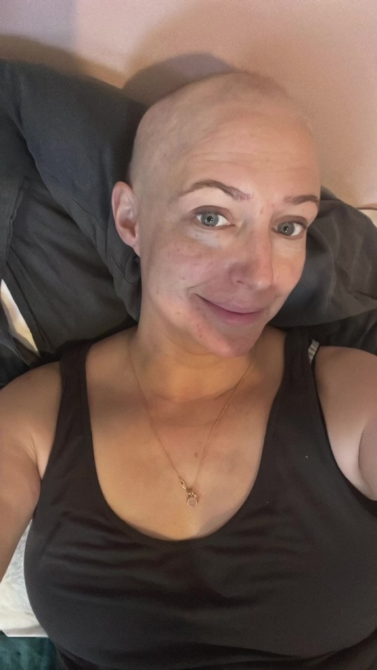 Close-up of a woman with a shaved head.