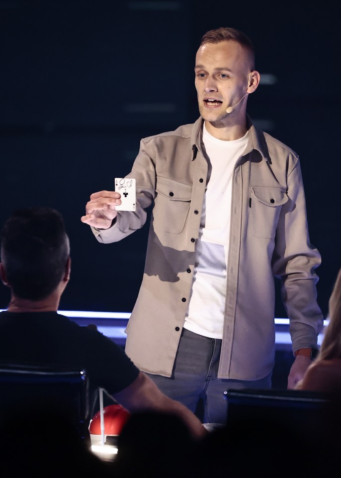 Jack Rhodes on Britain's Got Talent, holding up a playing card.