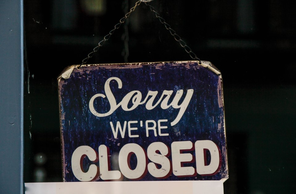 "Sorry, we're closed" sign in a window.