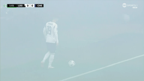 Soccer player on foggy field.