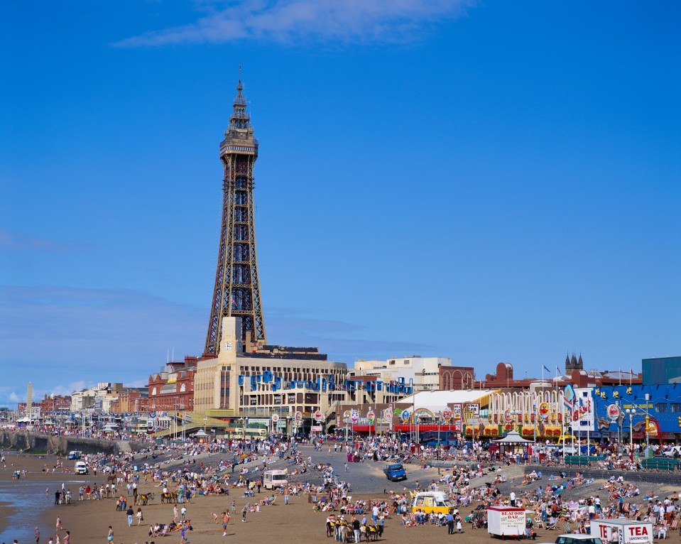 Crowded Blackpool beach with the Blackpool Tower in the background.