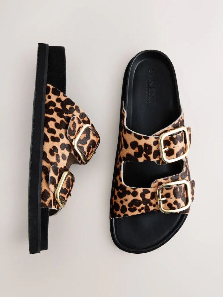 Leopard print sandals with gold buckles.