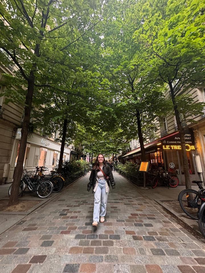 Woman walking down a Parisian street.