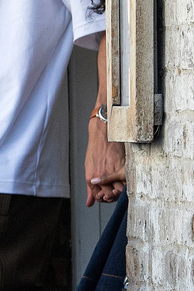 Maya Jama and Ruben Dias holding hands.