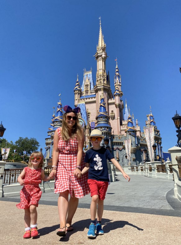 Family walking in front of Cinderella Castle at Disneyland.