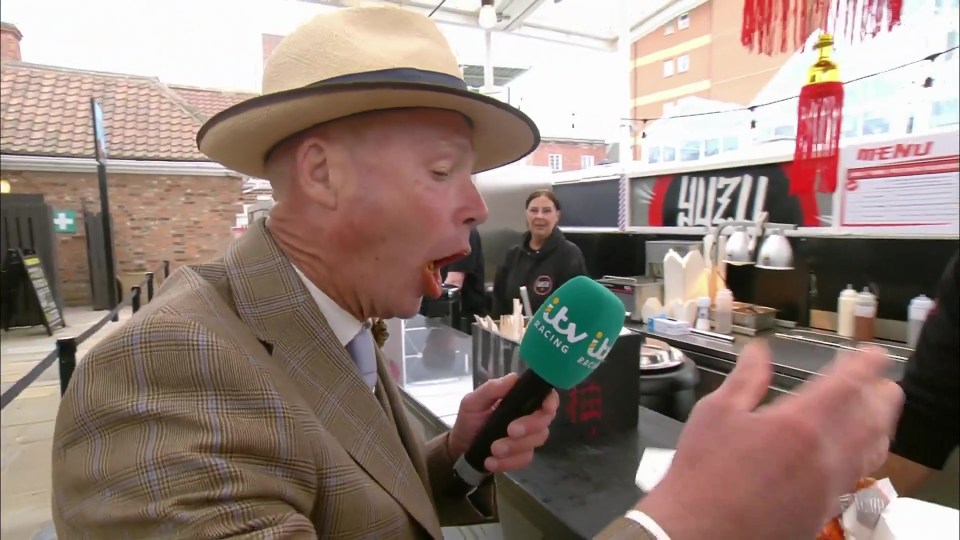ITV Racing presenter eating extremely spicy chicken wings while on live television.