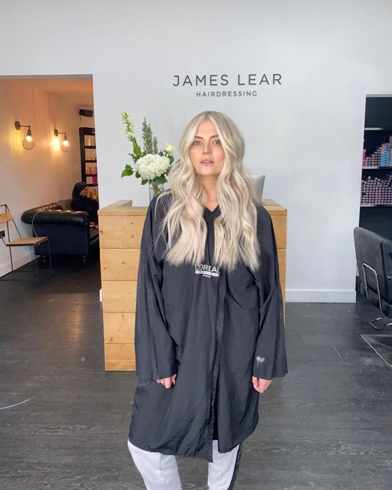 Woman with long blonde hair at James Lear Hairdressing.
