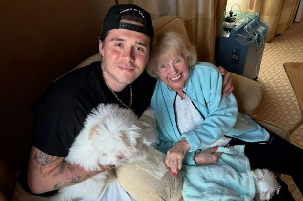An image collage containing 1 images, Image 1 shows Brooklyn Beckham with his grandmother and two small white dogs